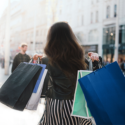 Lady carrying a lot of shopping bags