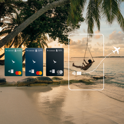 On a tropical sandy beach, a man sits on a swing hanging from the palm tree