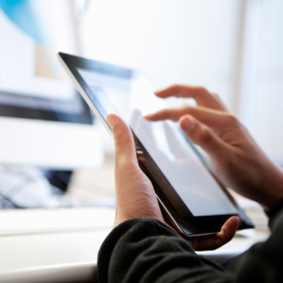 a person using tablet to search for SCB online banking services